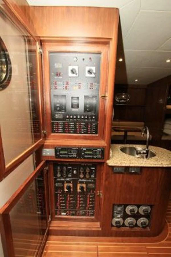 a wood cabinet with a glass door aboard WHITE LOTUS Yacht for Sale