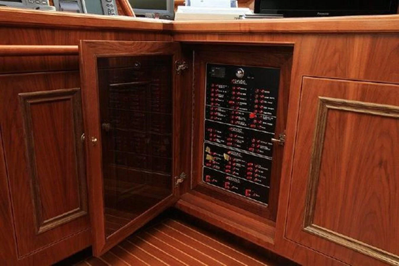 a wood cabinet with a screen aboard WHITE LOTUS Yacht for Sale