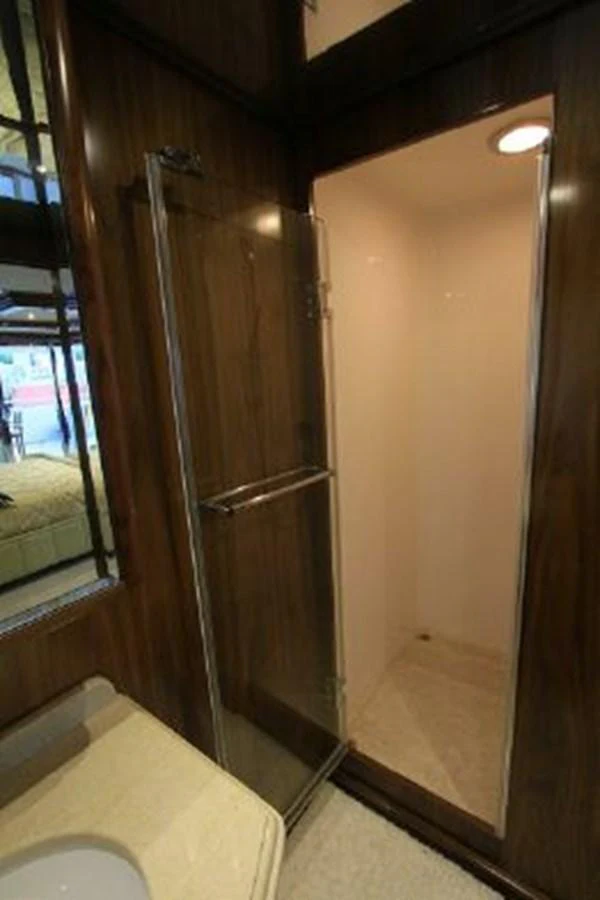 a bathroom with a wood door aboard WHITE LOTUS Yacht for Sale