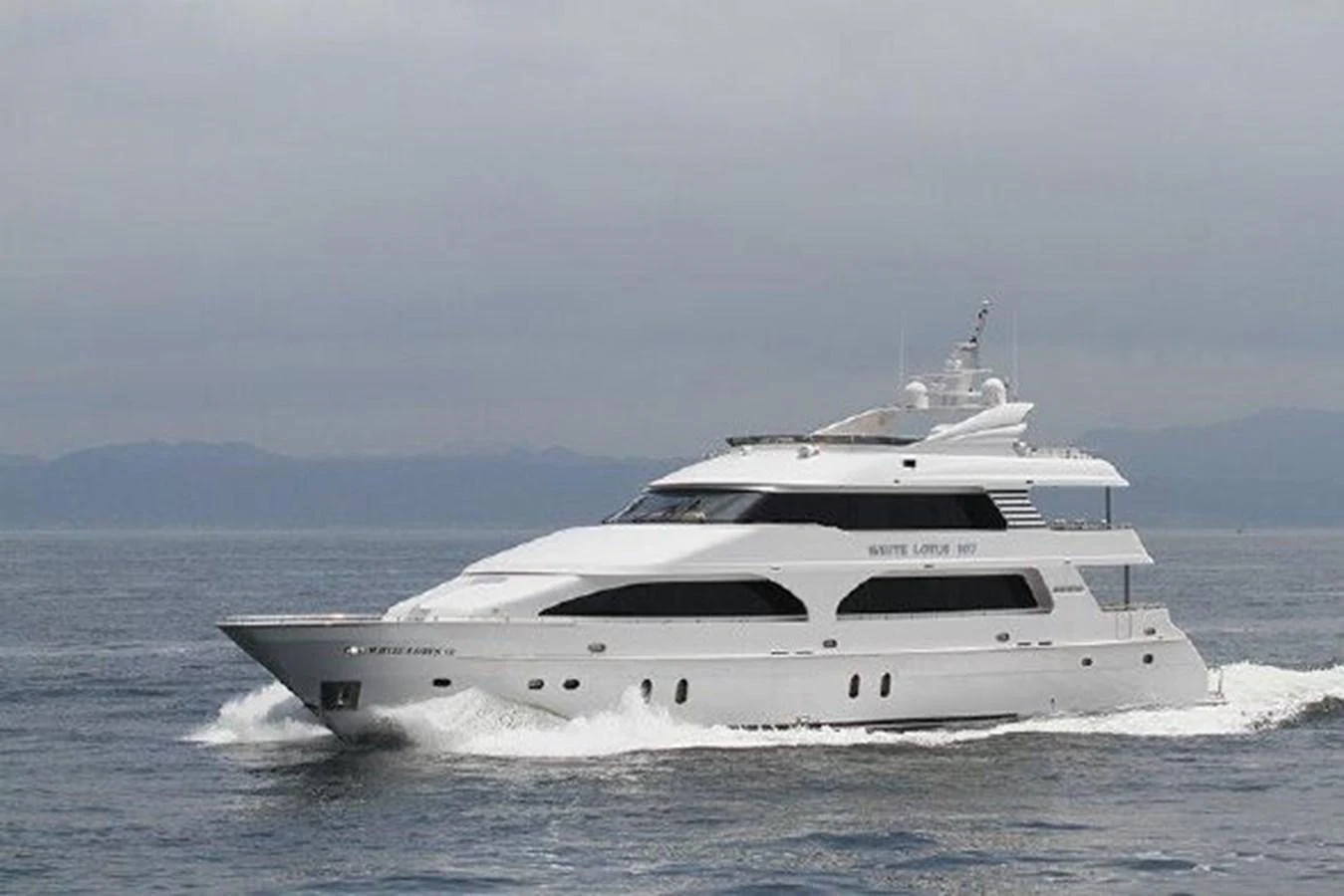 a white yacht on the water aboard WHITE LOTUS Yacht for Sale