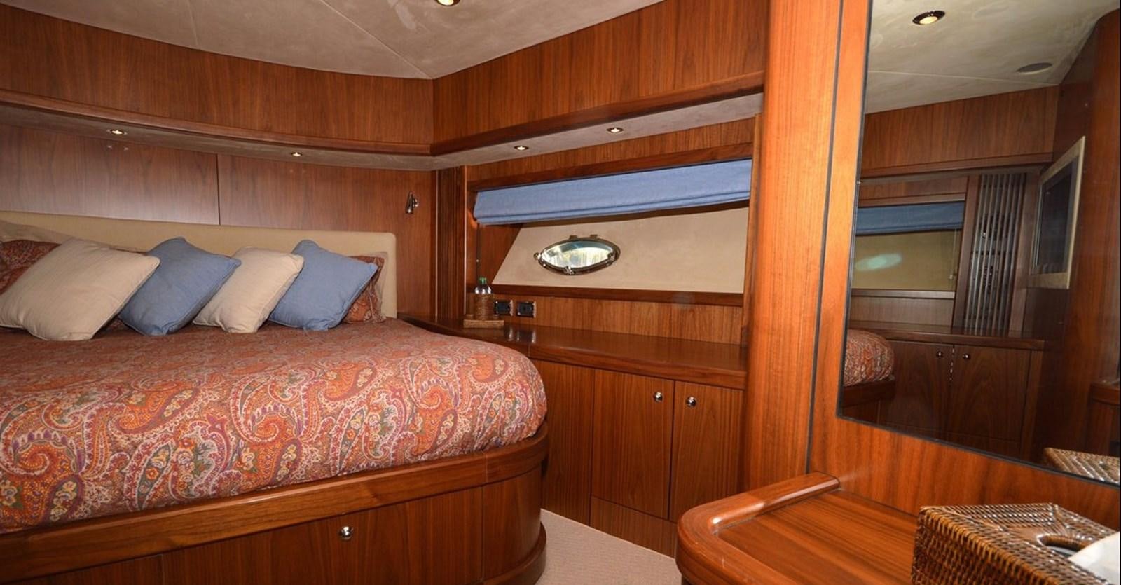 a room with a bed and a table aboard VA VA VROOM Yacht for Sale