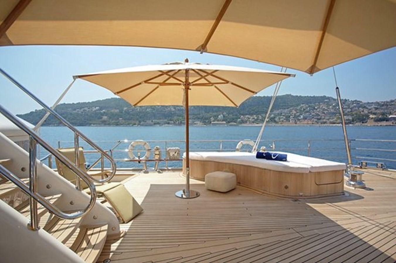 a lounge area with a large umbrella aboard LA LUNA Yacht for Sale