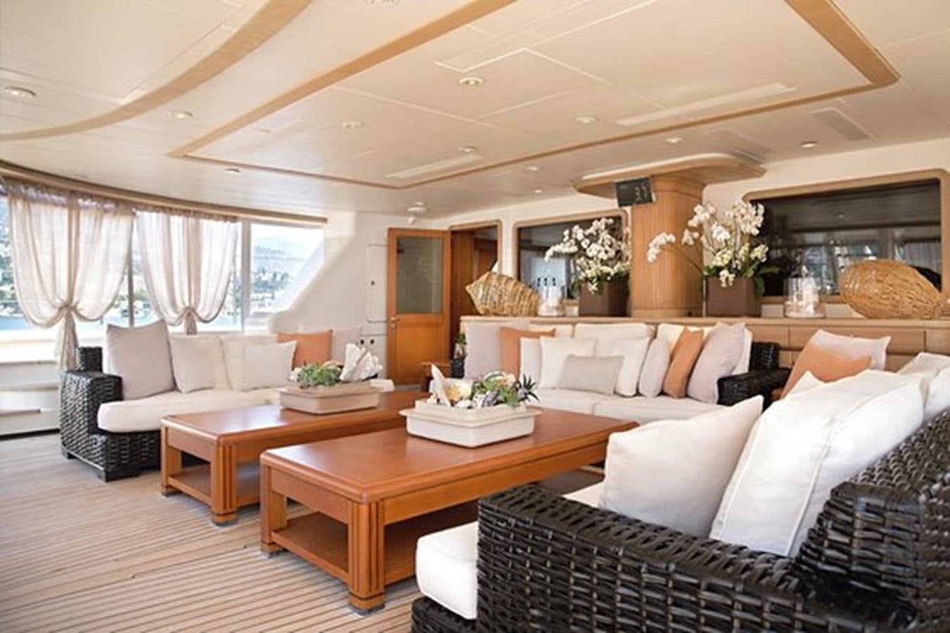 a living room with a table and couches aboard LA LUNA Yacht for Sale
