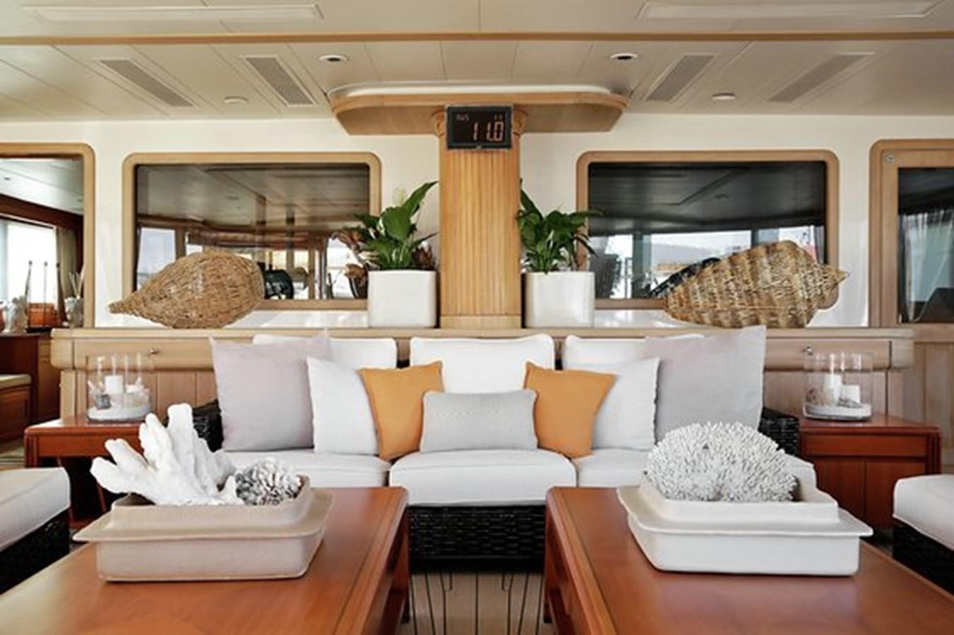 a living room with a white couch and a fireplace aboard LA LUNA Yacht for Sale