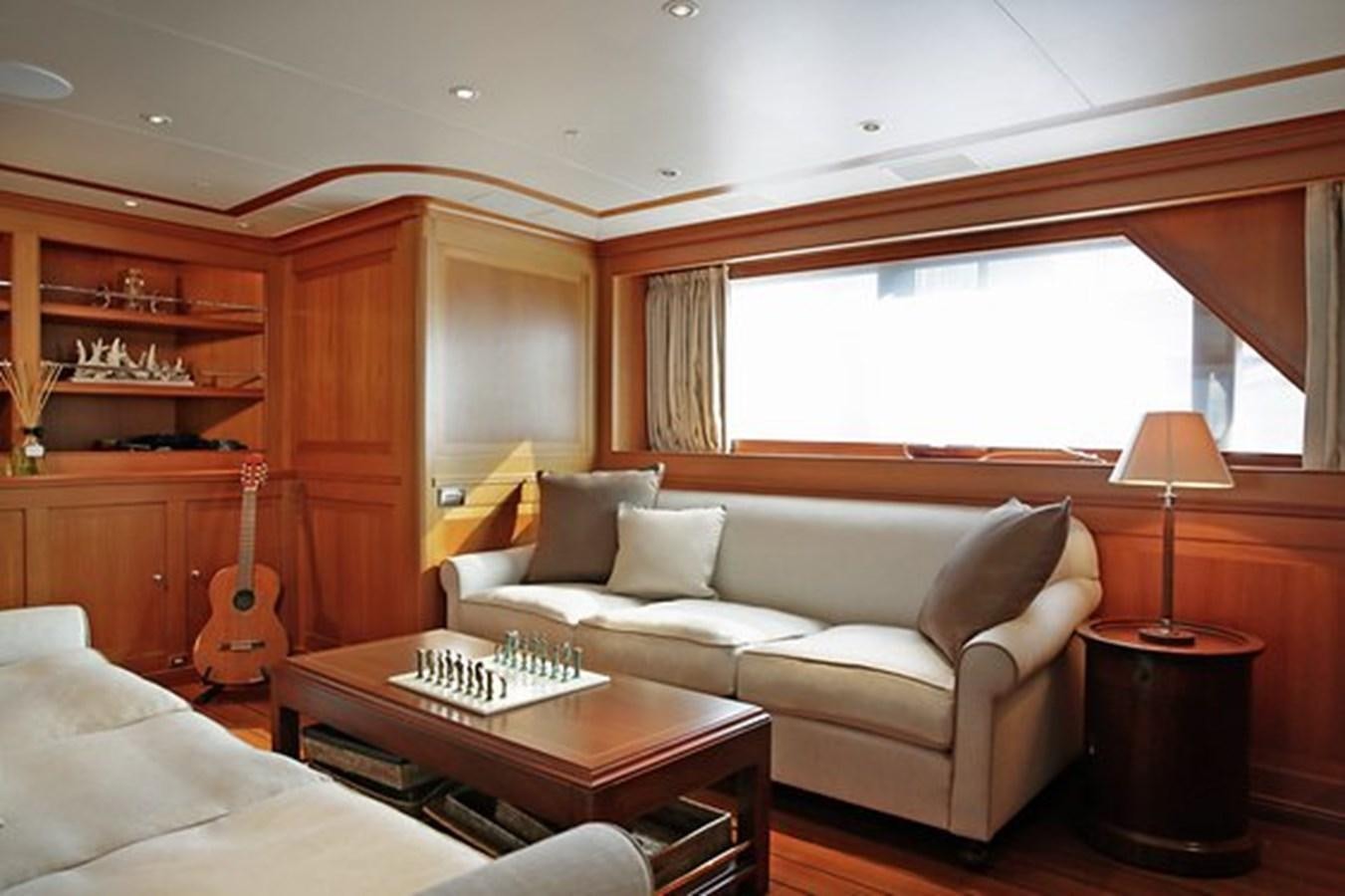 a living room with a couch and a table aboard LA LUNA Yacht for Sale