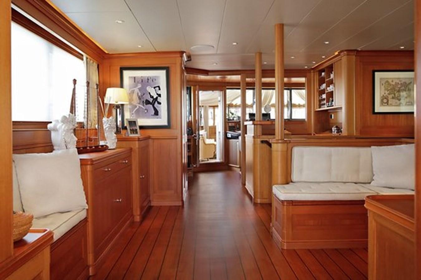 a bedroom with wood floors aboard LA LUNA Yacht for Sale