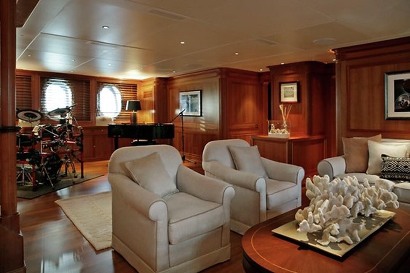 a living room with a piano and a piano aboard LA LUNA Yacht for Sale