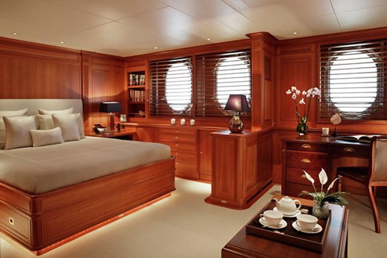 a bedroom with a bed and a desk aboard LA LUNA Yacht for Sale