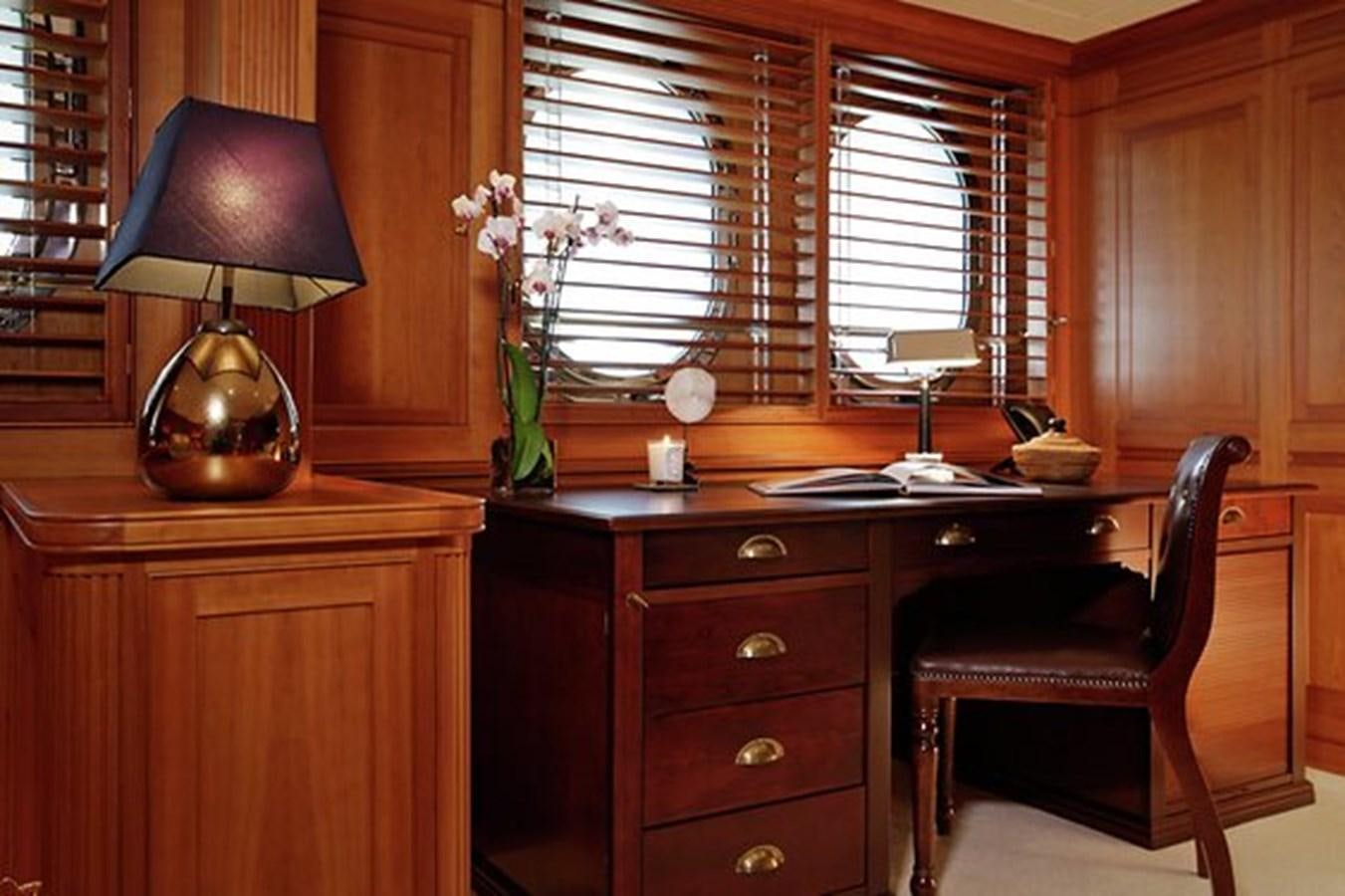 a room with a desk and a lamp aboard LA LUNA Yacht for Sale