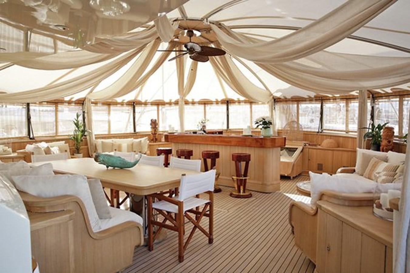 a large room with tables and chairs aboard LA LUNA Yacht for Sale
