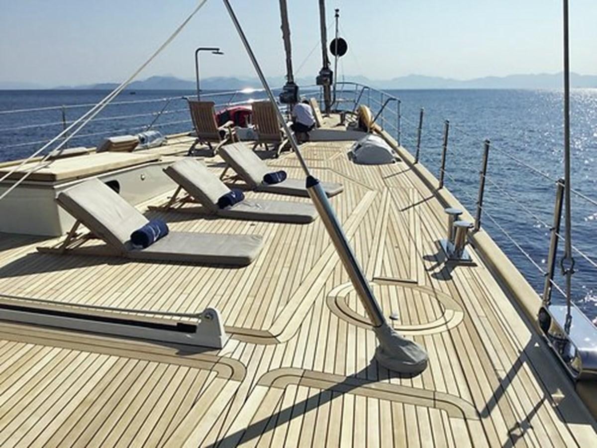 a deck with a deck and chairs on it aboard LA LUNA Yacht for Sale