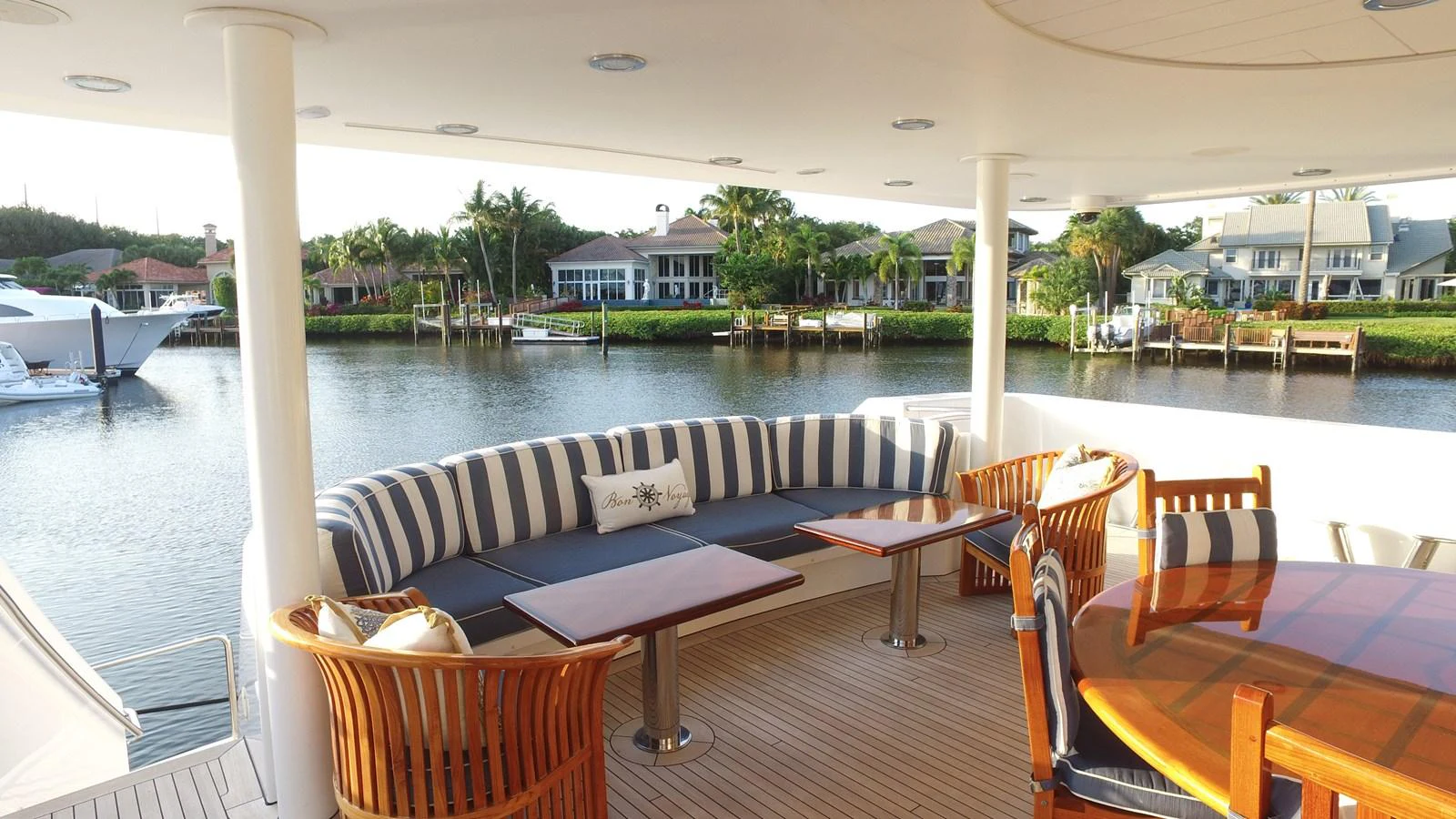a patio with tables and chairs aboard SHORT GAME Yacht for Sale
