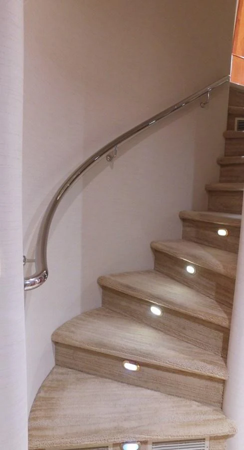 a wooden staircase with a metal railing aboard SHORT GAME Yacht for Sale