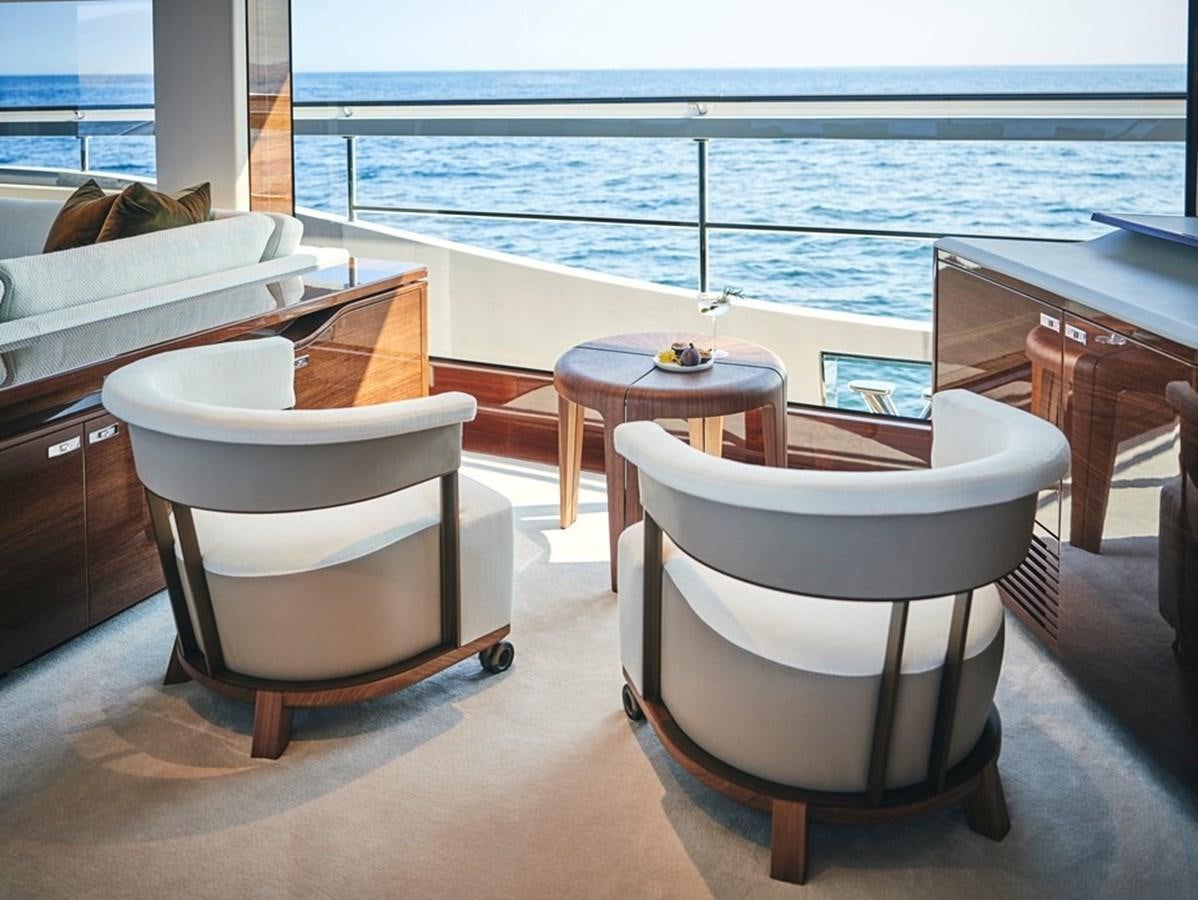 a couple of chairs on a balcony overlooking the ocean aboard ROVAL Yacht for Sale