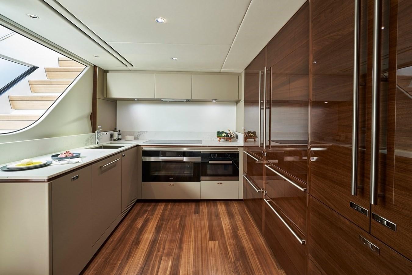 a kitchen with a wooden floor aboard ROVAL Yacht for Sale