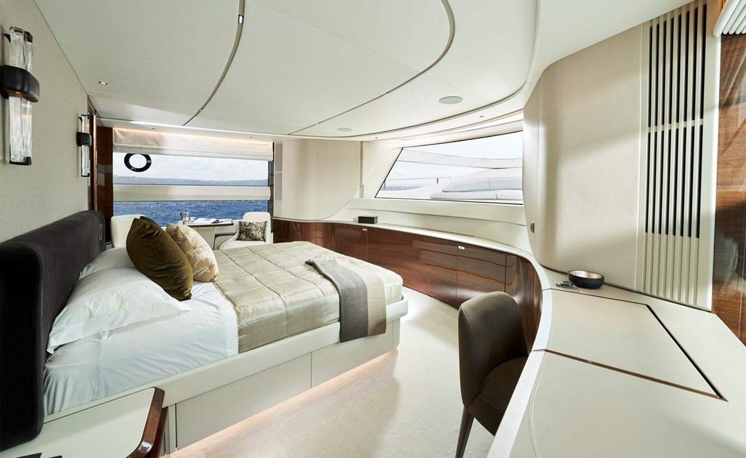 a room with a bed and a chair aboard ROVAL Yacht for Sale
