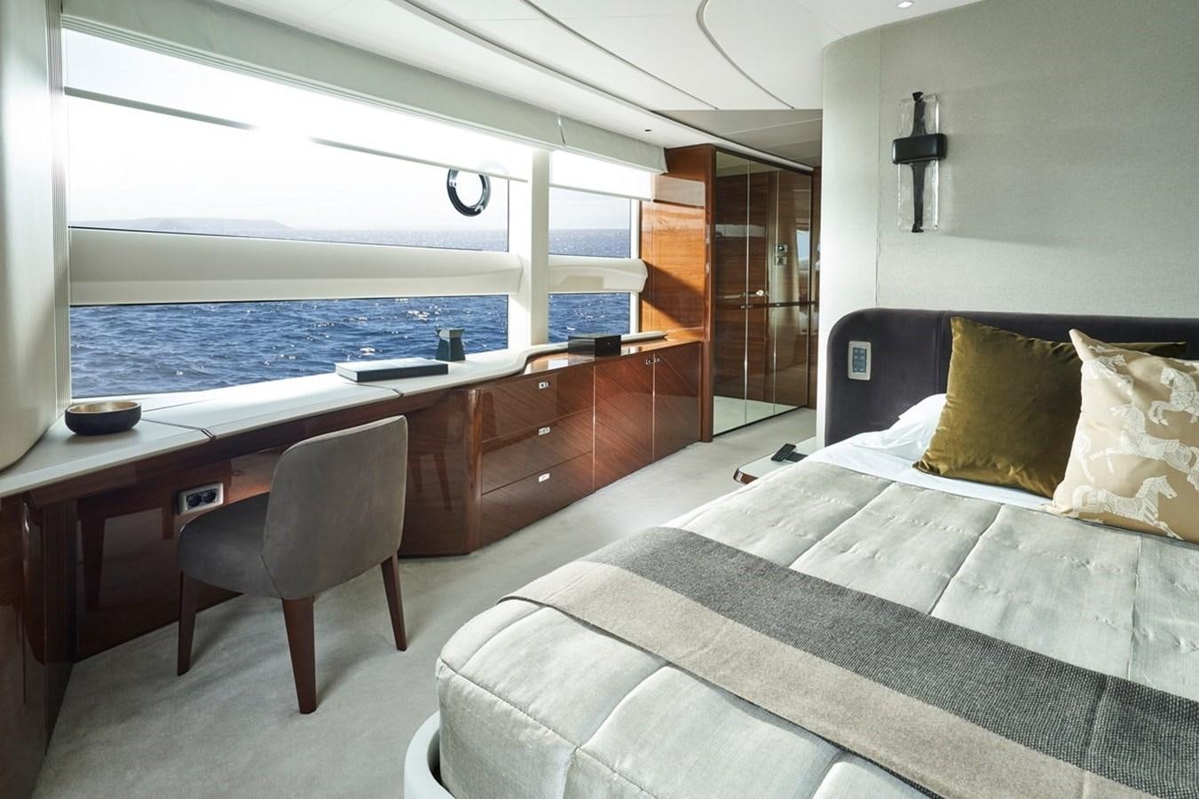 a room with a bed and a desk aboard ROVAL Yacht for Sale