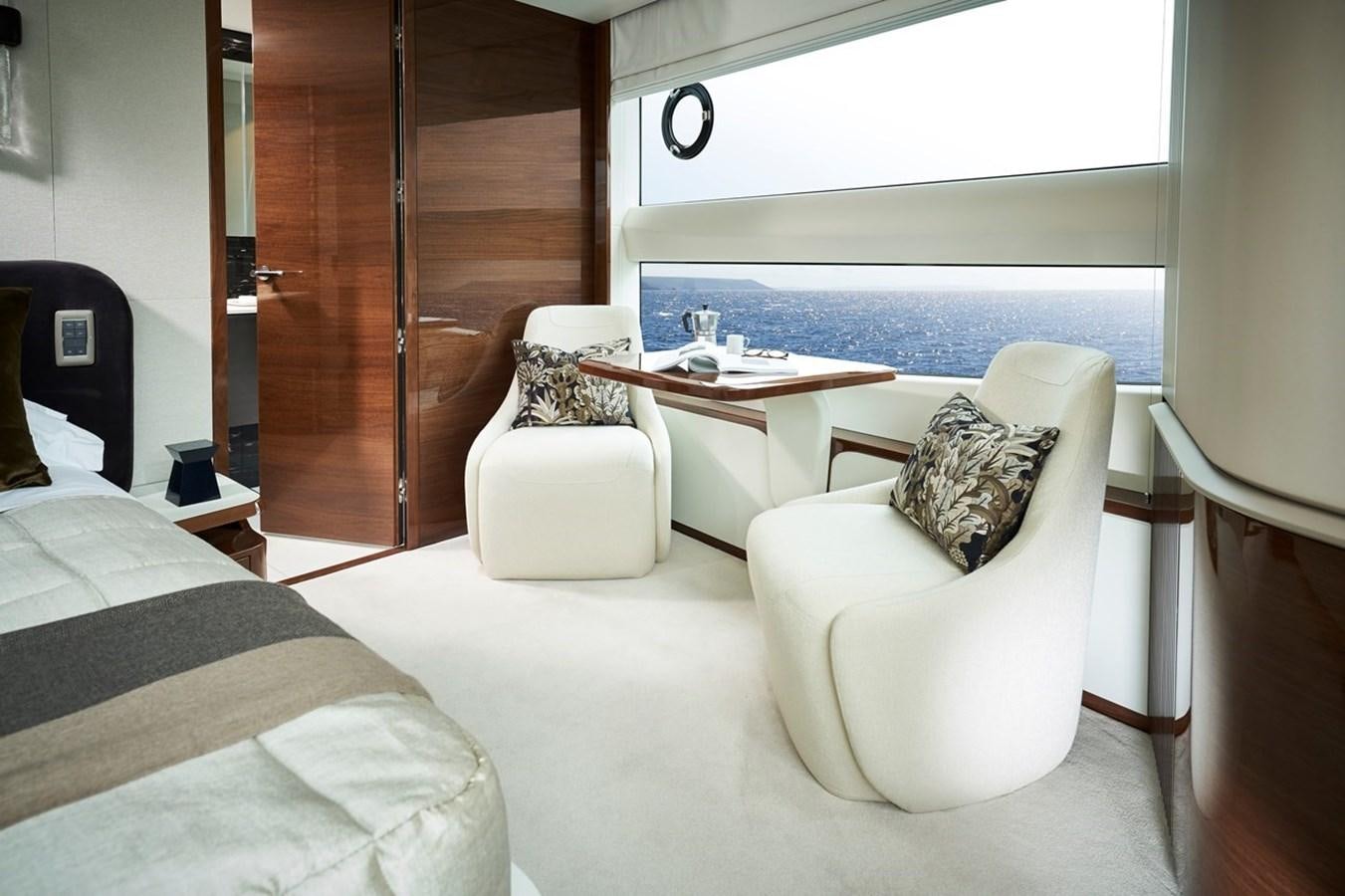 a room with a table and chairs aboard ROVAL Yacht for Sale