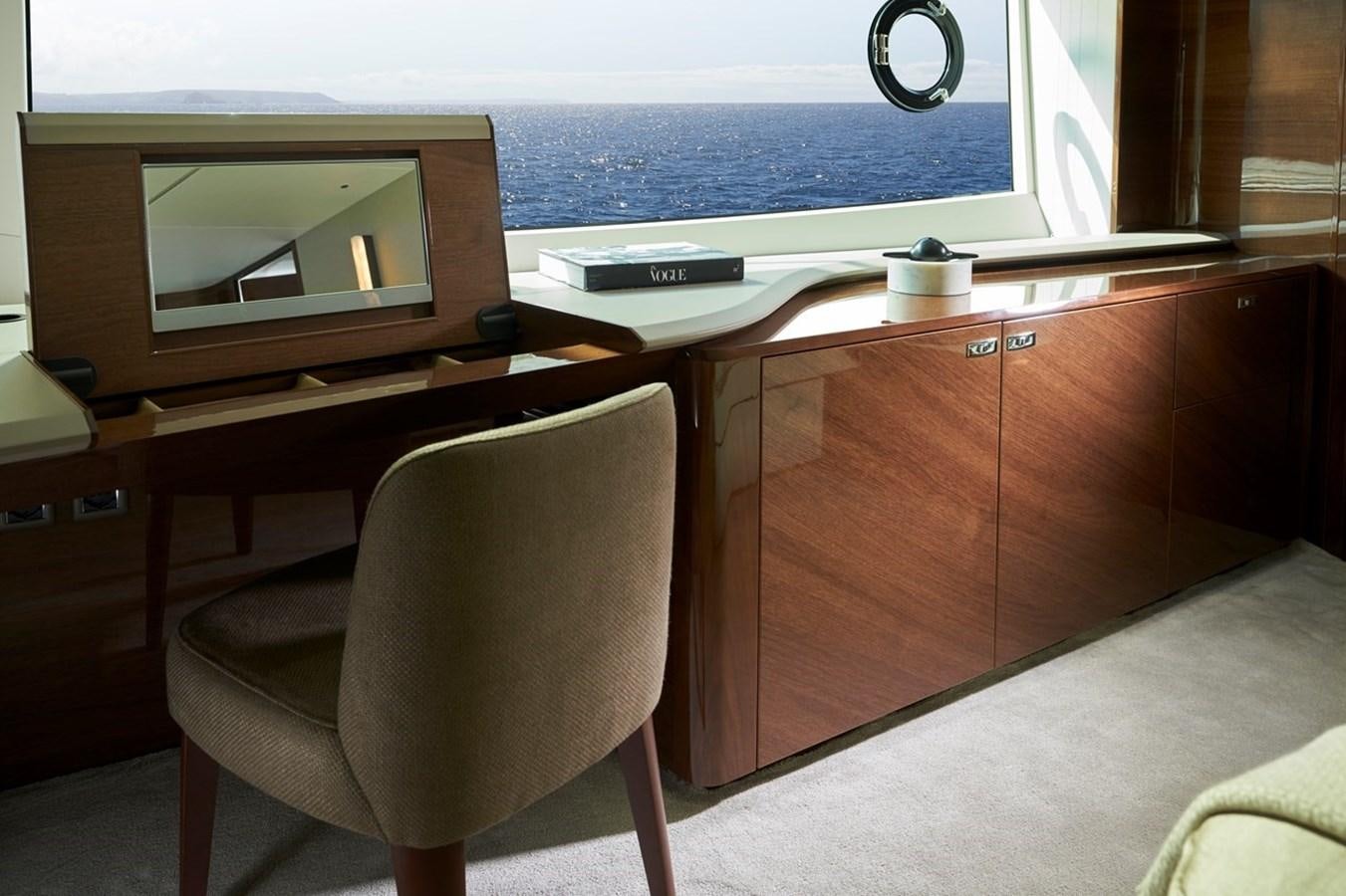a chair in front of a desk aboard ROVAL Yacht for Sale