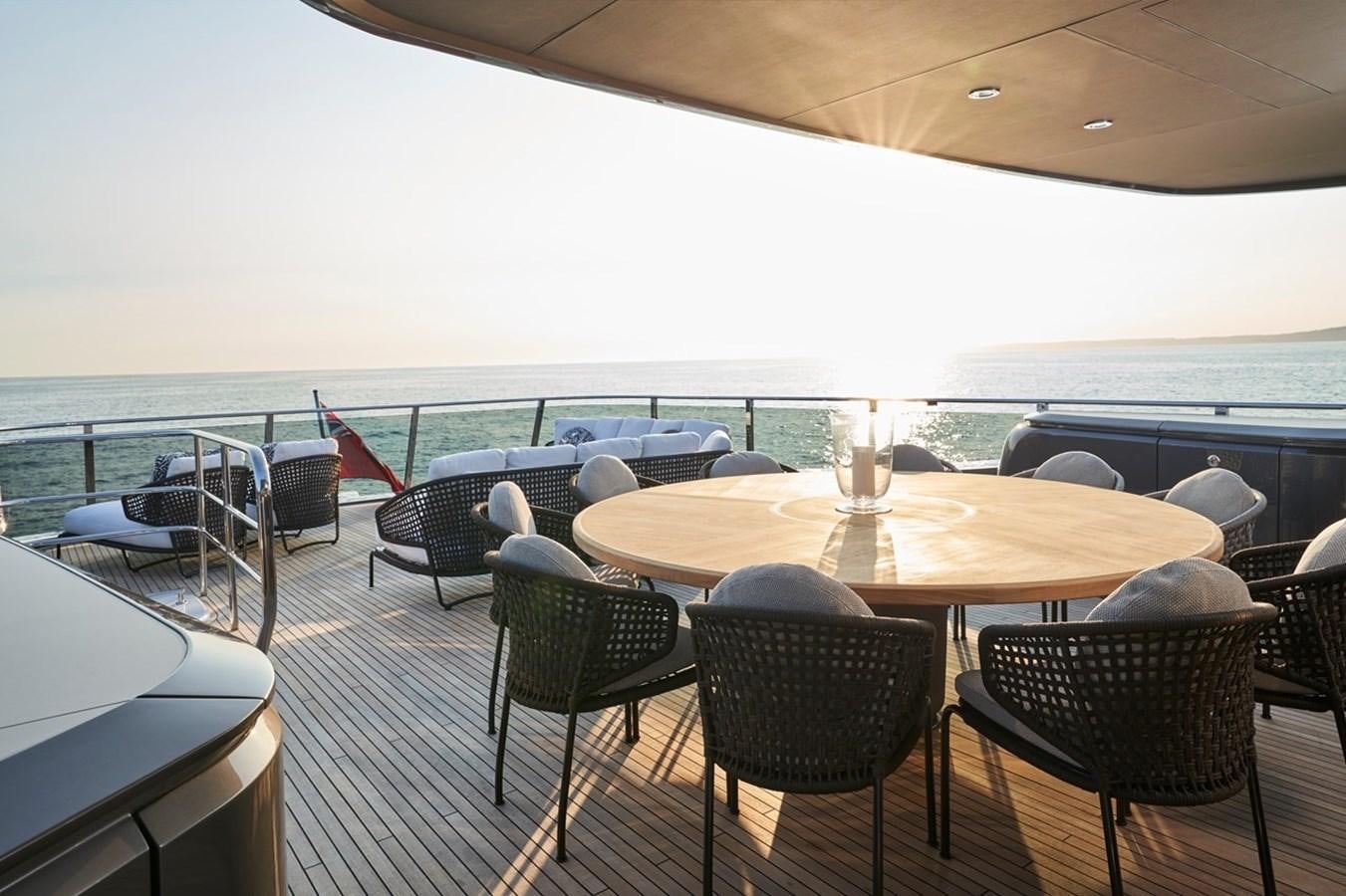 a table with chairs on it aboard ROVAL Yacht for Sale