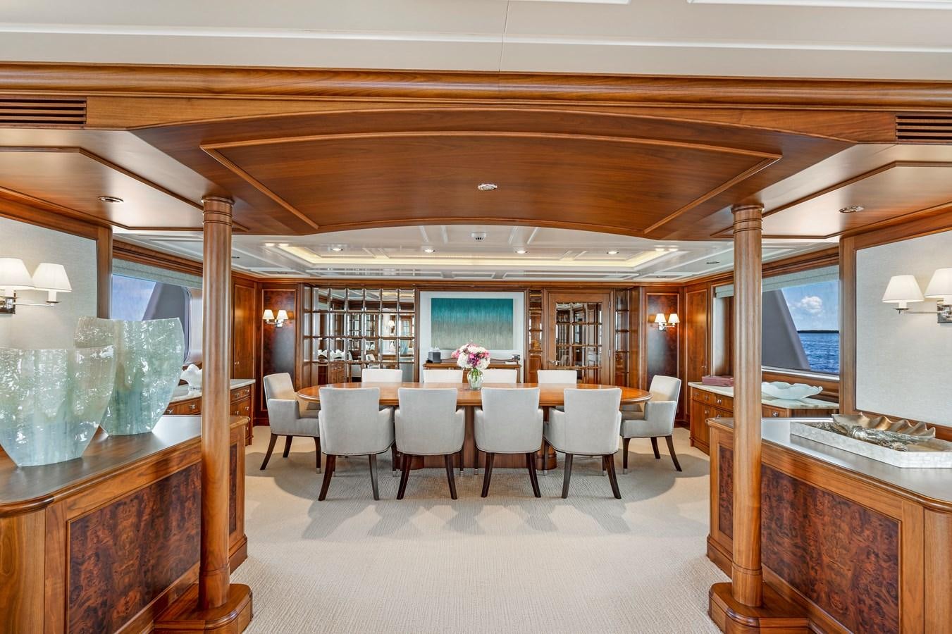 a room with tables and chairs aboard BIG EASY Yacht for Charter