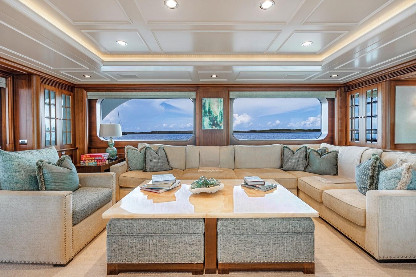 a living room with a couch and a table aboard BIG EASY Yacht for Charter