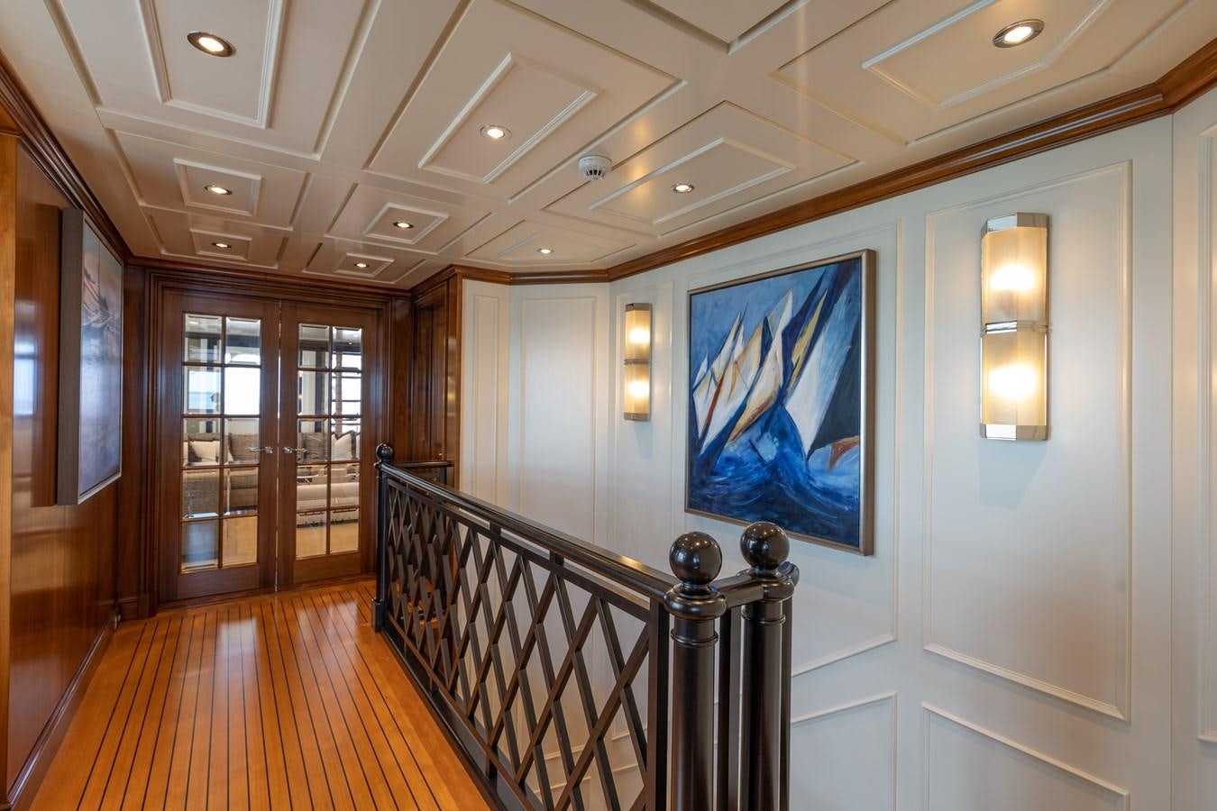 a large room with wood floors and a staircase aboard BIG EASY Yacht for Charter
