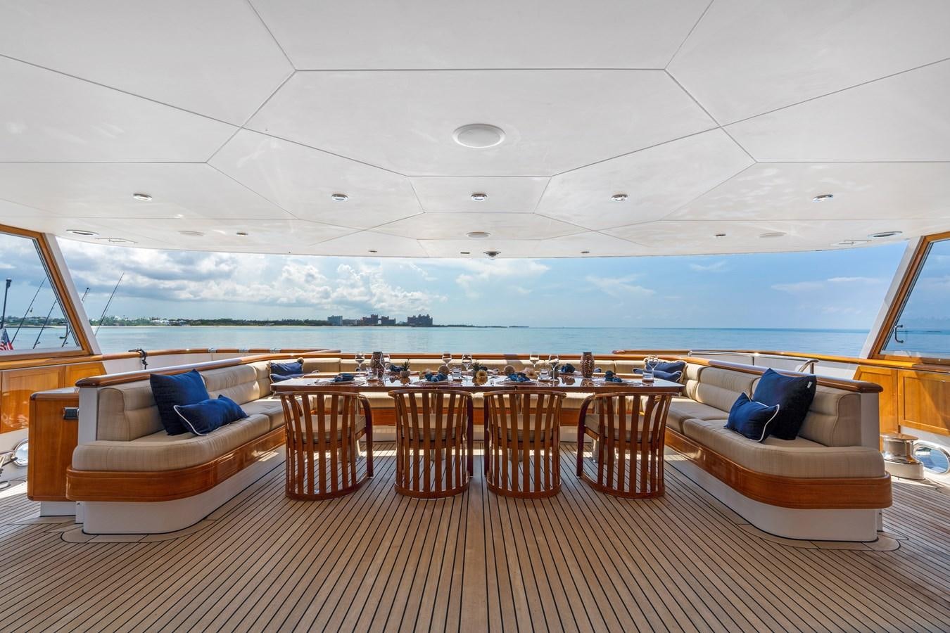 a room with a large table and chairs and a large body of water aboard BIG EASY Yacht for Charter