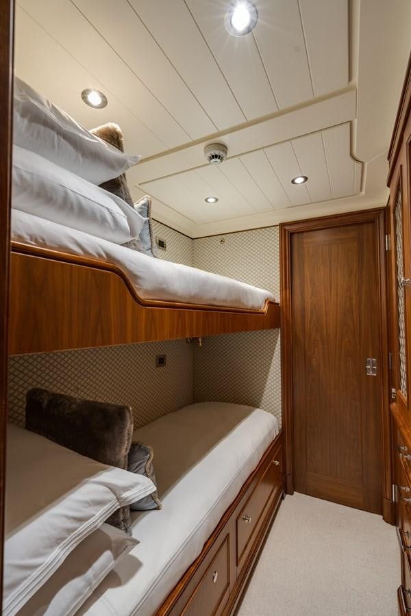 a room with a bed and a closet aboard BIG EASY Yacht for Charter