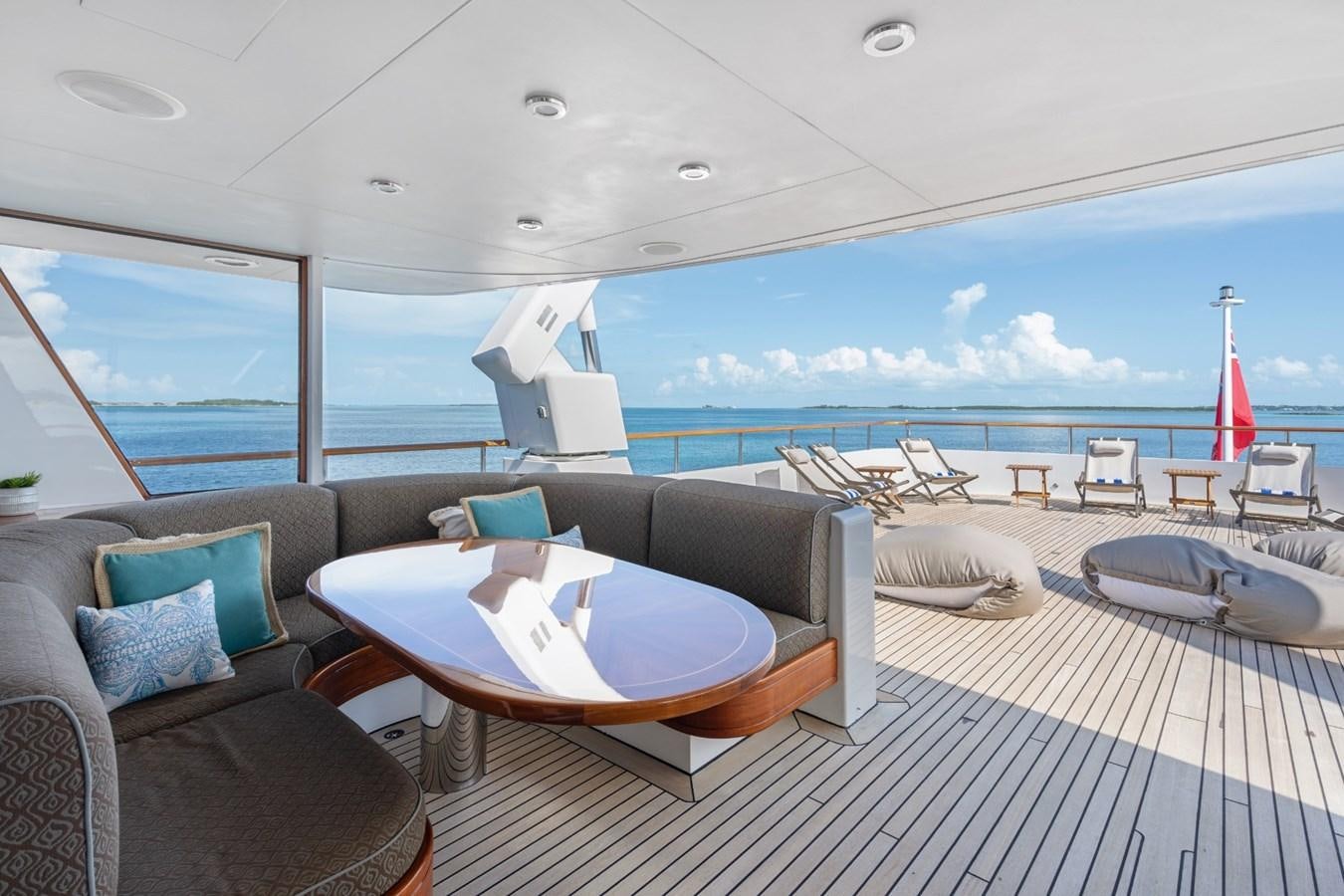 a large living room with a large balcony overlooking the ocean aboard BIG EASY Yacht for Charter