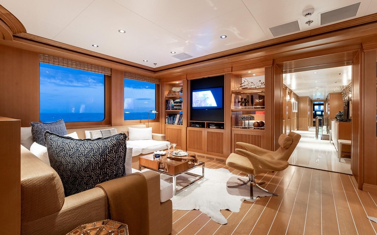 a living room with a large screen aboard TREEHOUSE Yacht for Sale