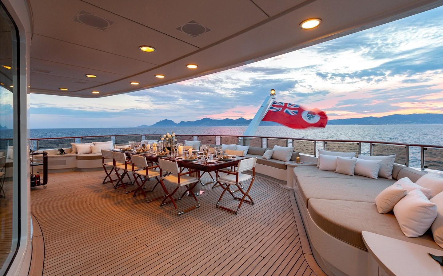 a room with a table and chairs and a large body of water aboard TREEHOUSE Yacht for Sale