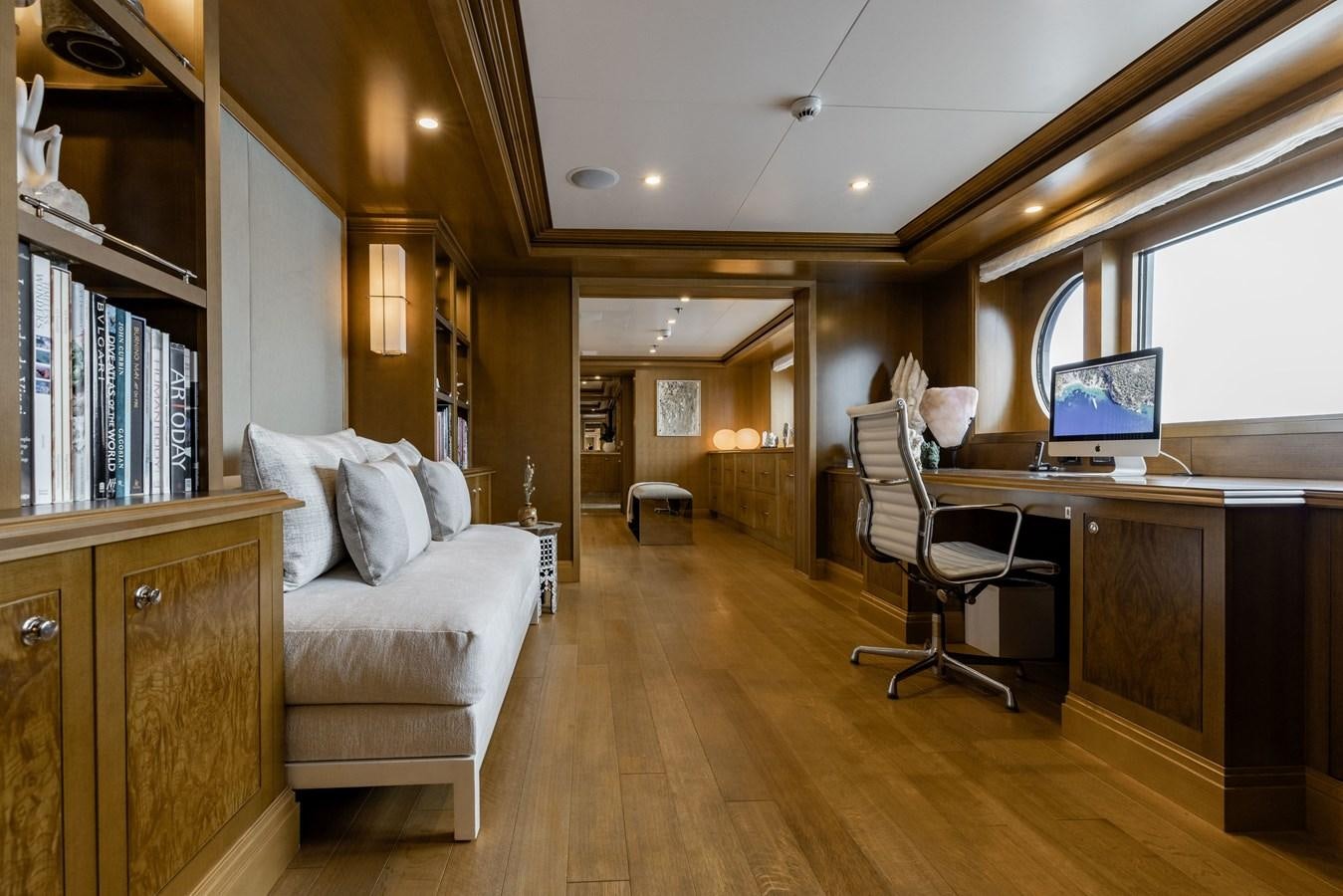 a living room with a desk and a couch aboard TREEHOUSE Yacht for Sale