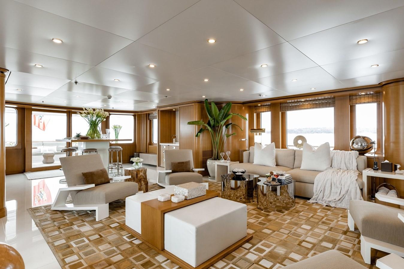 a living room with a large white sofa and a table aboard TREEHOUSE Yacht for Sale