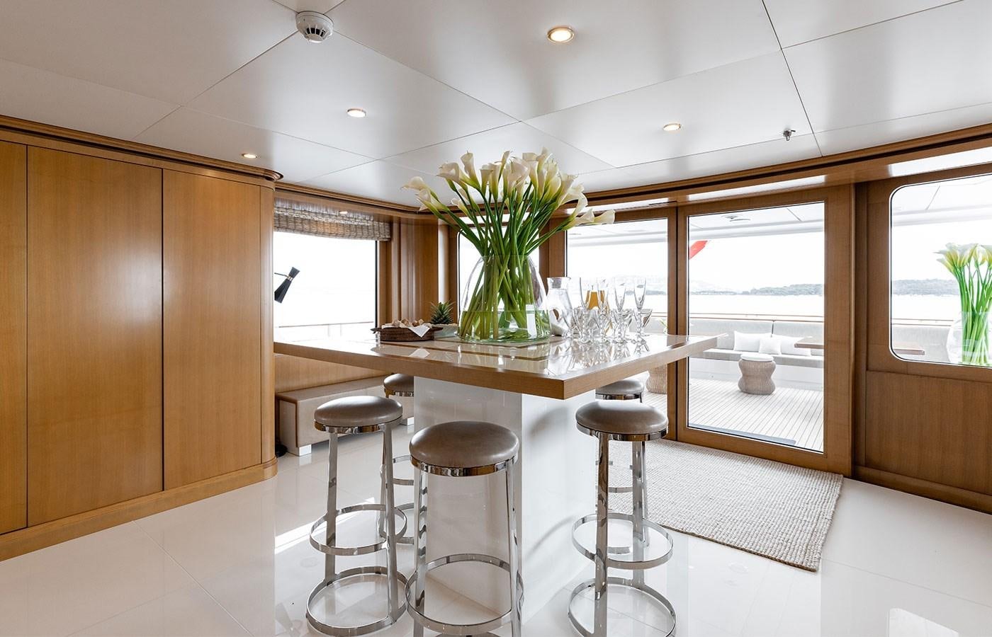 a kitchen with stools and a countertop aboard TREEHOUSE Yacht for Sale