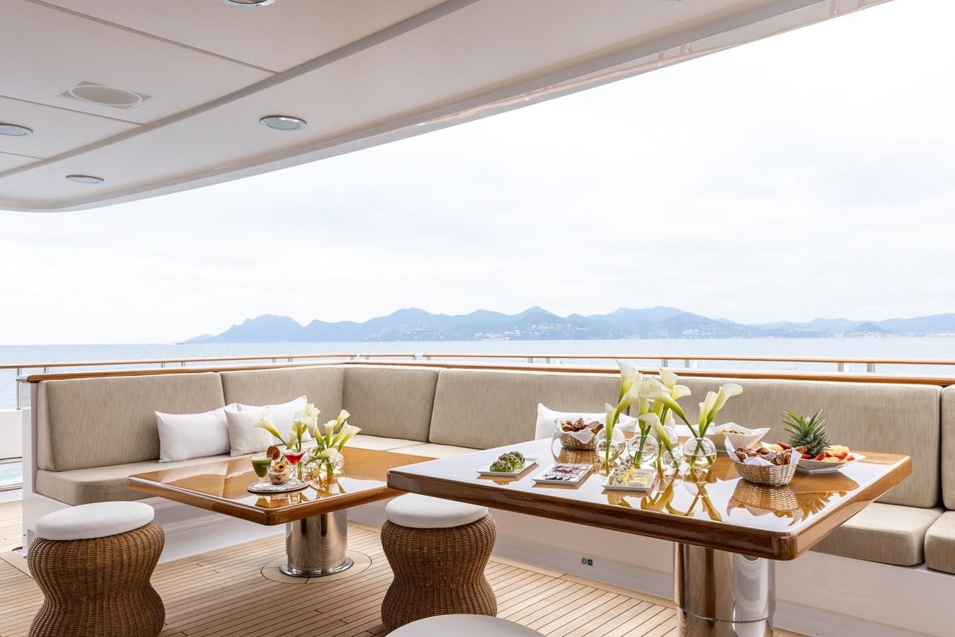 a table with chairs and a couch aboard TREEHOUSE Yacht for Sale