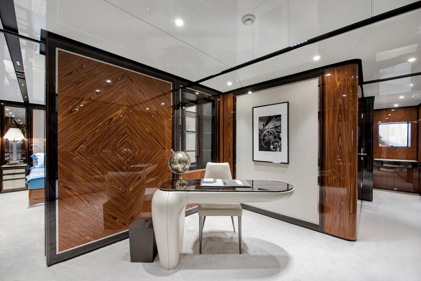 a room with a table and chairs aboard STERN Yacht for Sale