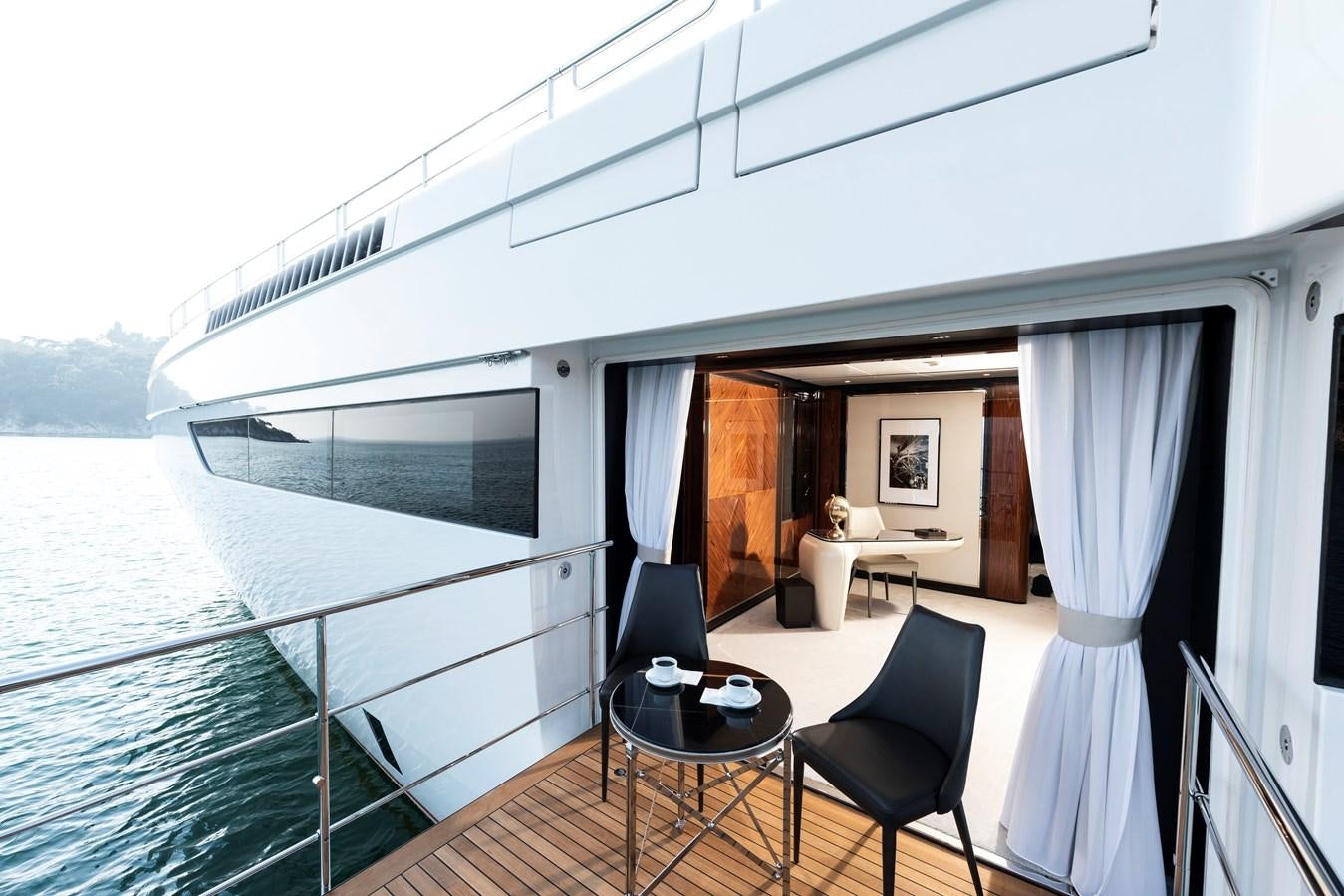 a room with a table and chairs aboard STERN Yacht for Sale