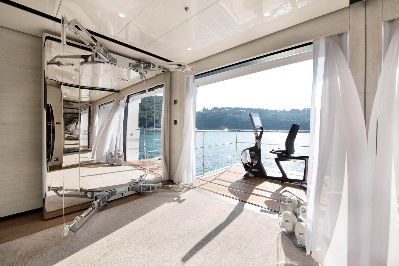 a room with a large window and a view of the water aboard STERN Yacht for Sale