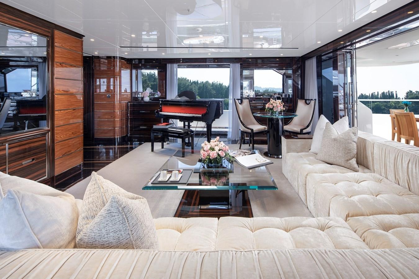 a living room with a piano and a table aboard STERN Yacht for Sale