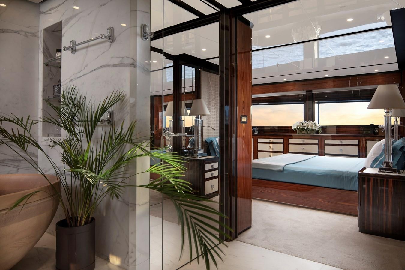 a room with a bed and a plant aboard STERN Yacht for Sale