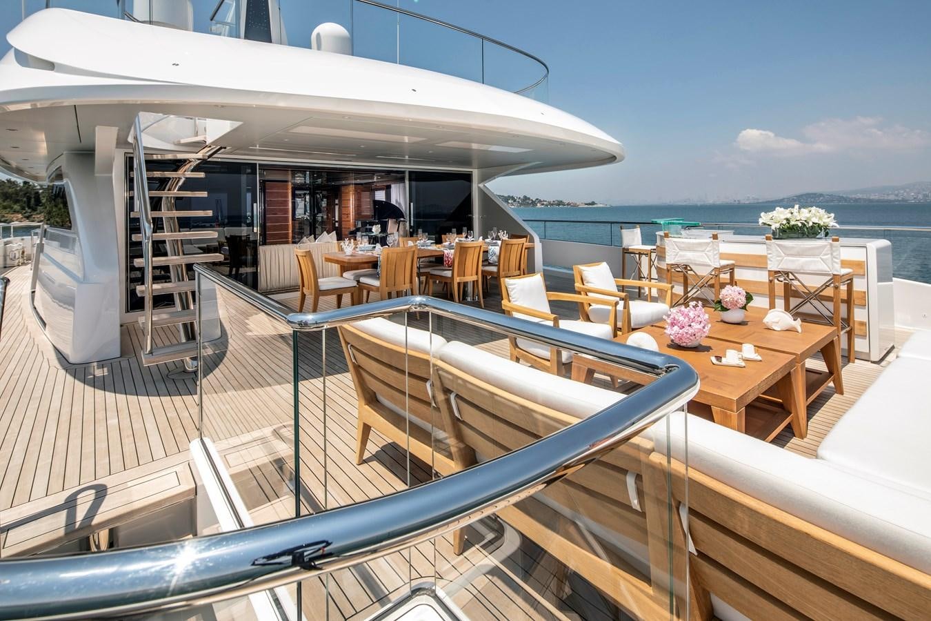 a room with a balcony and a view of the ocean aboard STERN Yacht for Sale