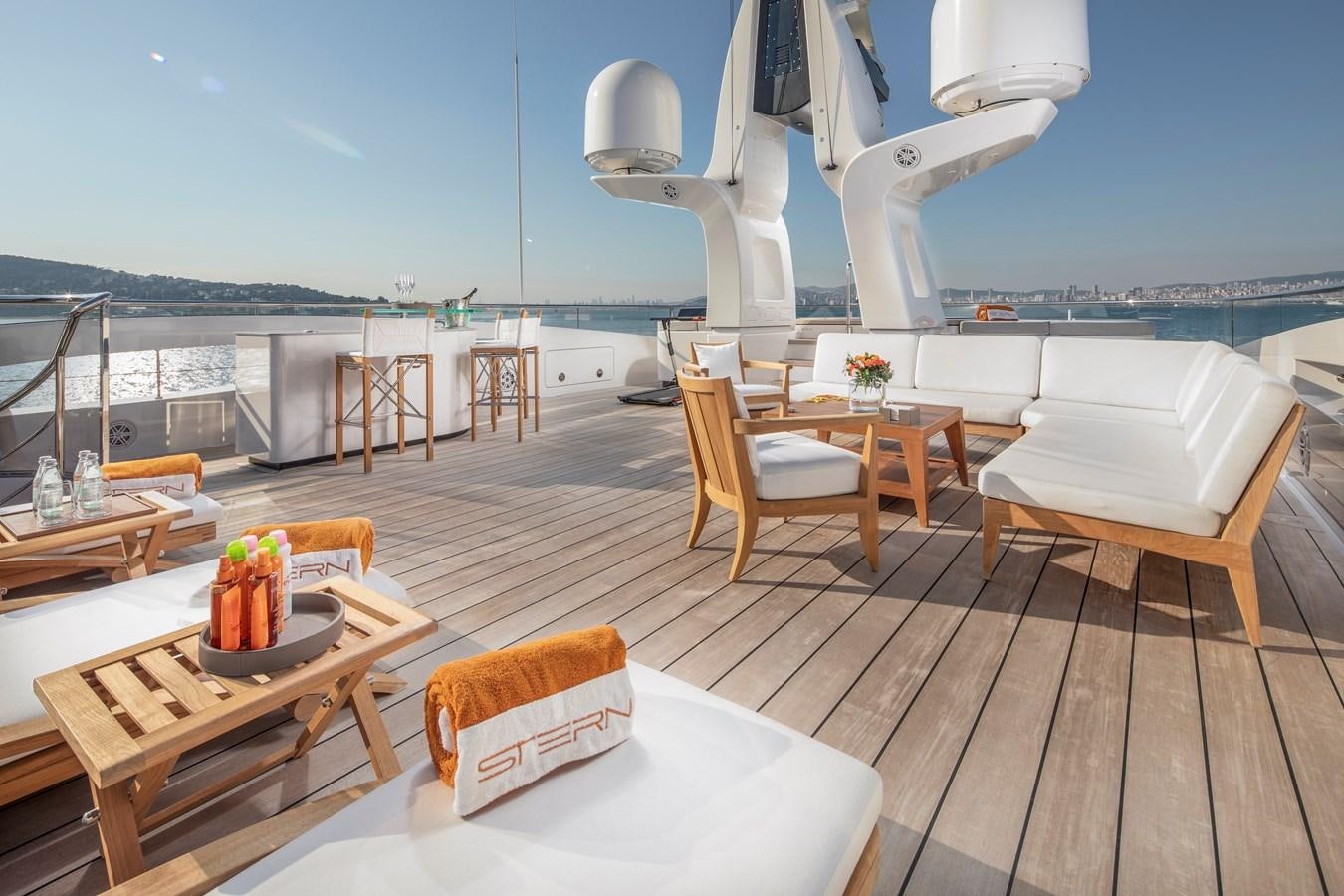 a room with a wood floor and chairs and a large body of water aboard STERN Yacht for Sale
