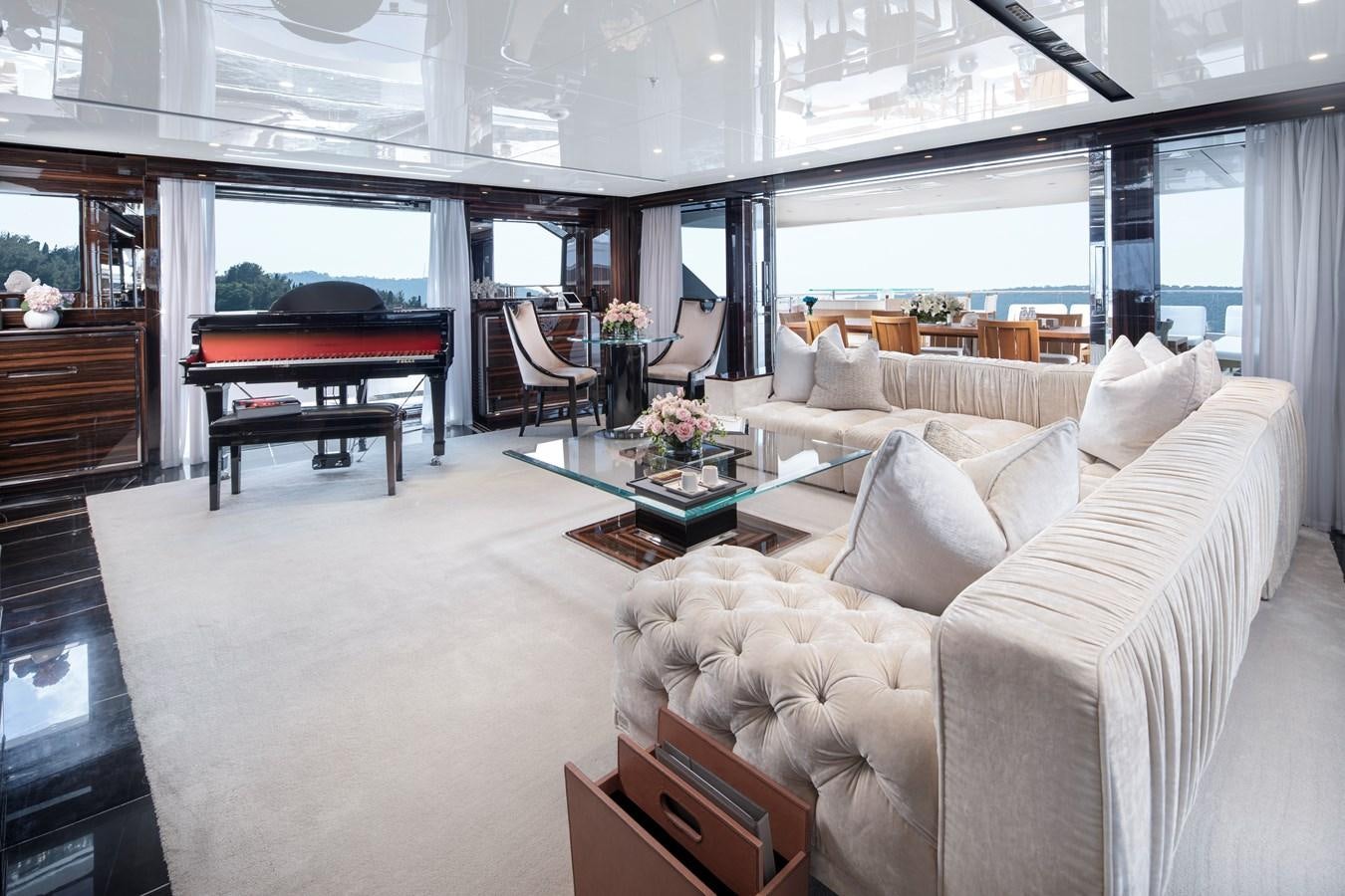 a living room with a piano aboard STERN Yacht for Sale