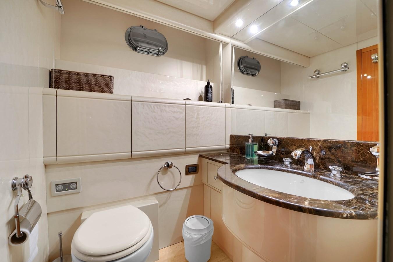 a bathroom with a sink toilet and a mirror aboard HAKUNA MATATA Yacht for Sale