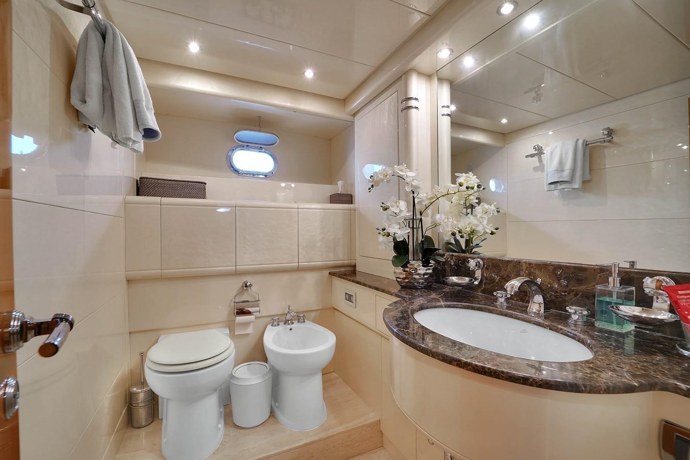 a bathroom with a sink toilet and a mirror aboard HAKUNA MATATA Yacht for Sale