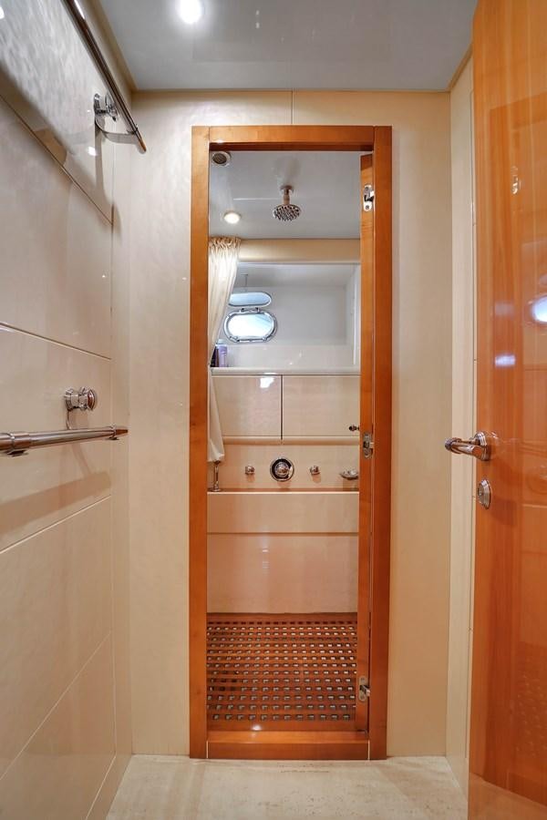 a bathroom with a glass door aboard HAKUNA MATATA Yacht for Sale
