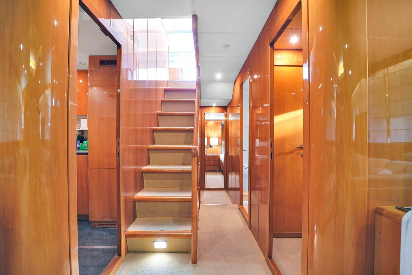a hallway with wooden doors aboard HAKUNA MATATA Yacht for Sale