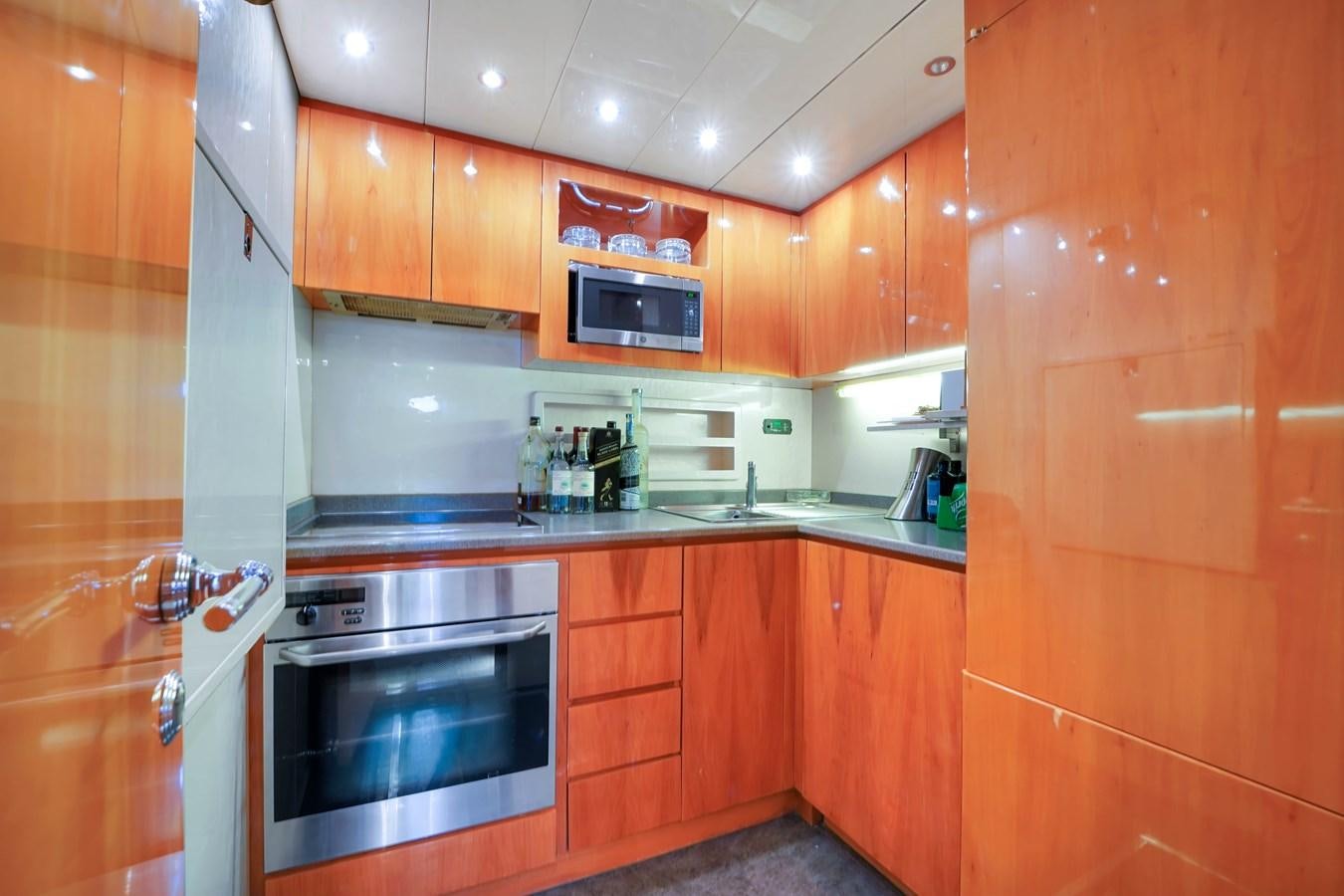 a kitchen with wooden cabinets aboard HAKUNA MATATA Yacht for Sale