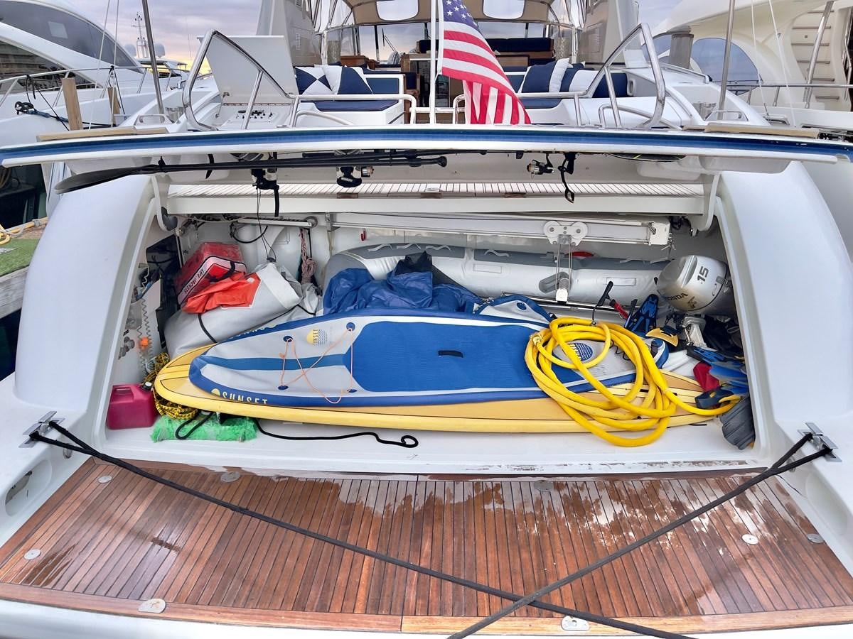a boat with a flag on the deck aboard HAKUNA MATATA Yacht for Sale